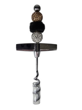 Decorative corkscrew with decorative balls on a white background