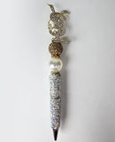 Signed in Luxury | Gold Monogram Crystal Topper & White Pearl Pen